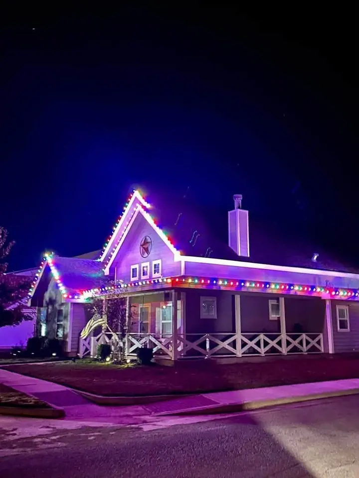 The porch glowing with multicolor Christmas lights