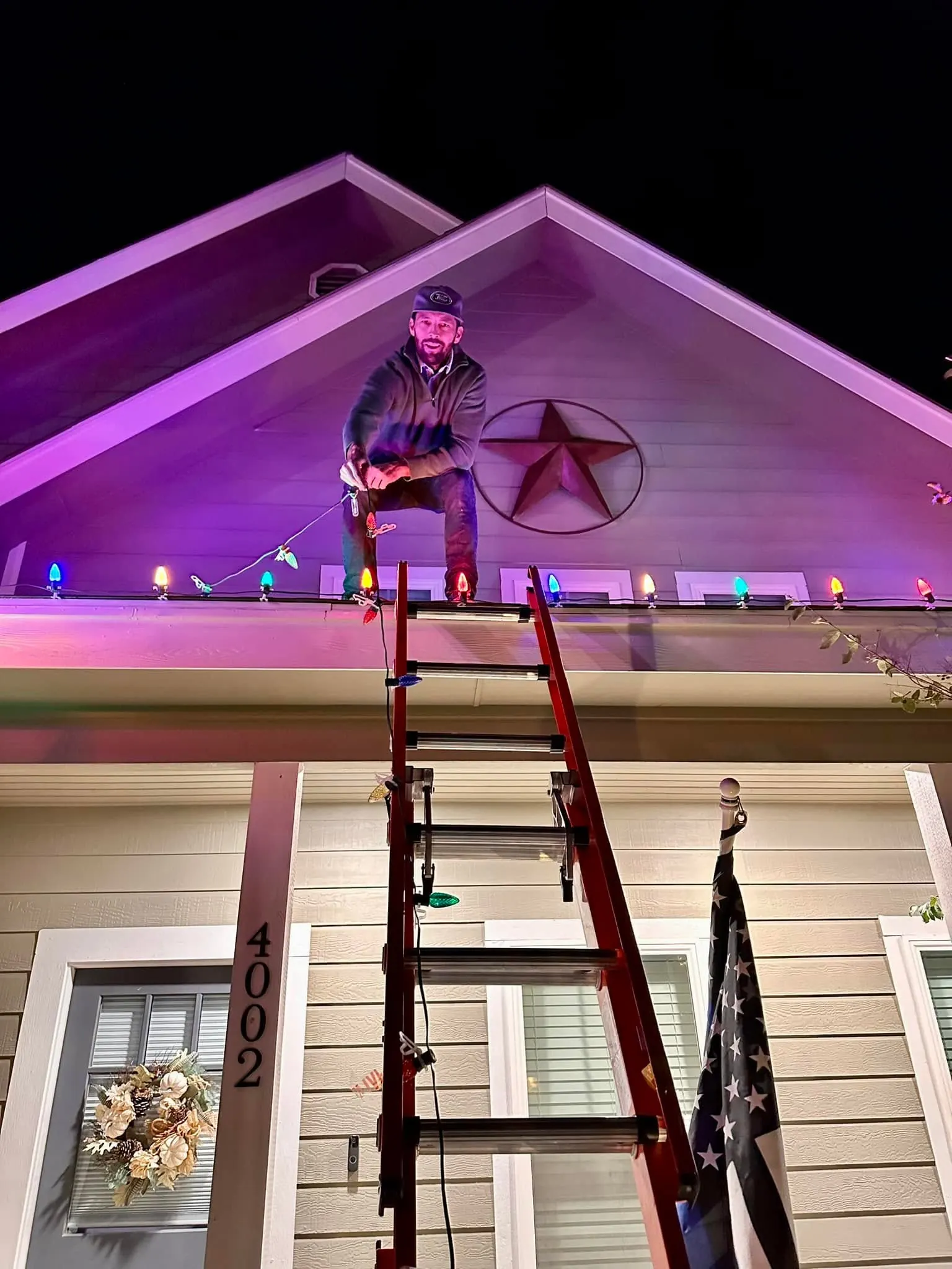 Our Christmas light installer working on a home's festive roofline